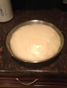 After 1.5 hours the dough is ready. Take the plastic wrap of, flour a surface of the counter and knead the dough a bit more. 